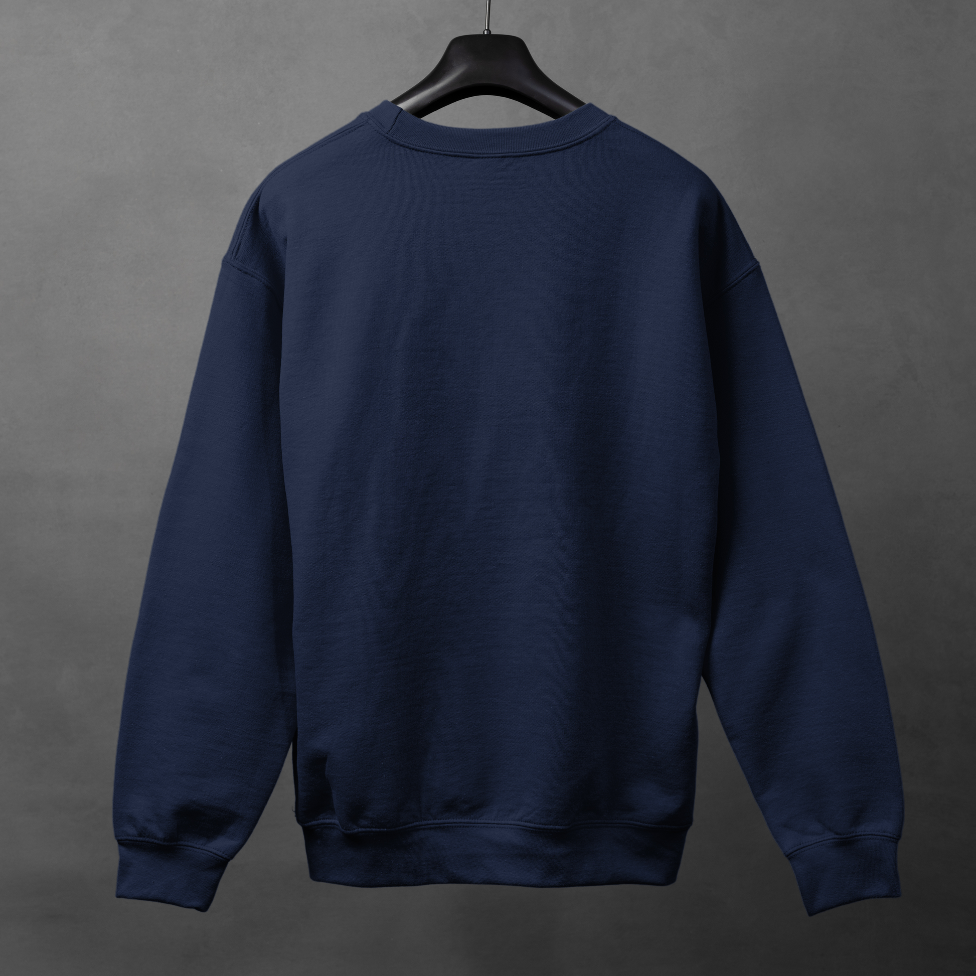Navy blue sweatshirt on a hanger against a gray background