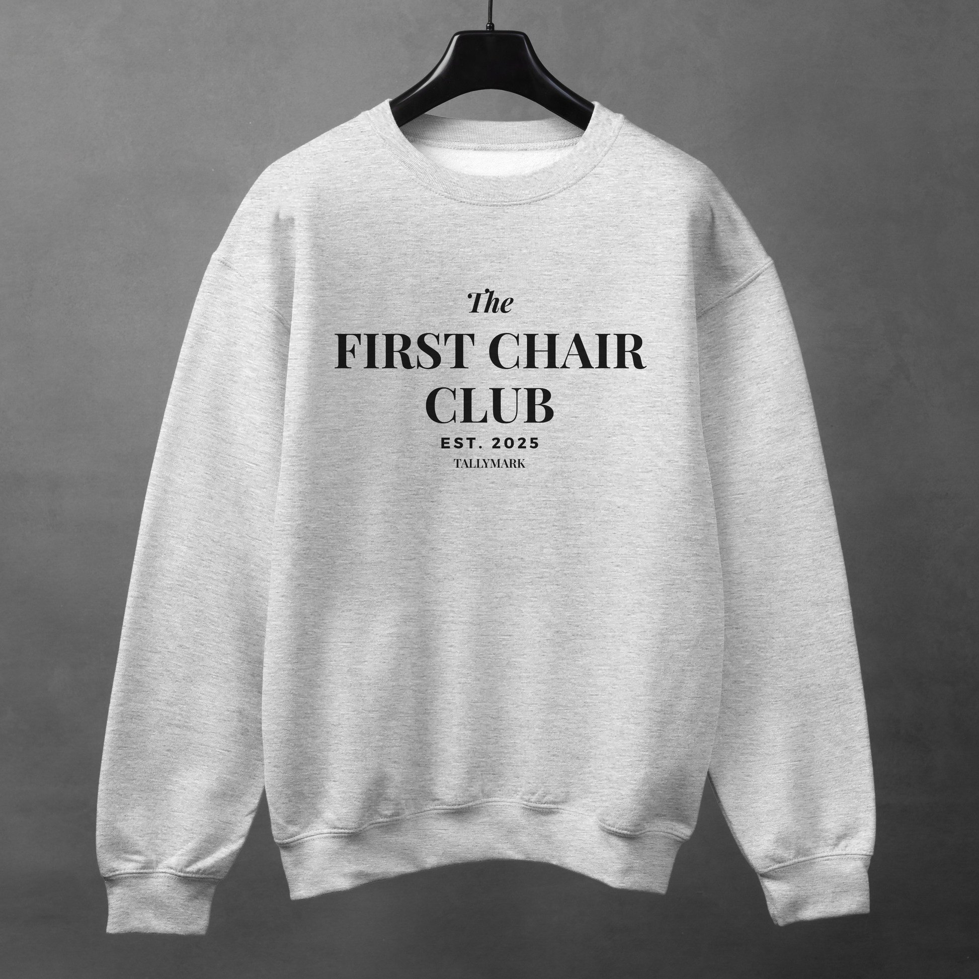 Gray sweatshirt with 'The First Chair Club' text on a gray background