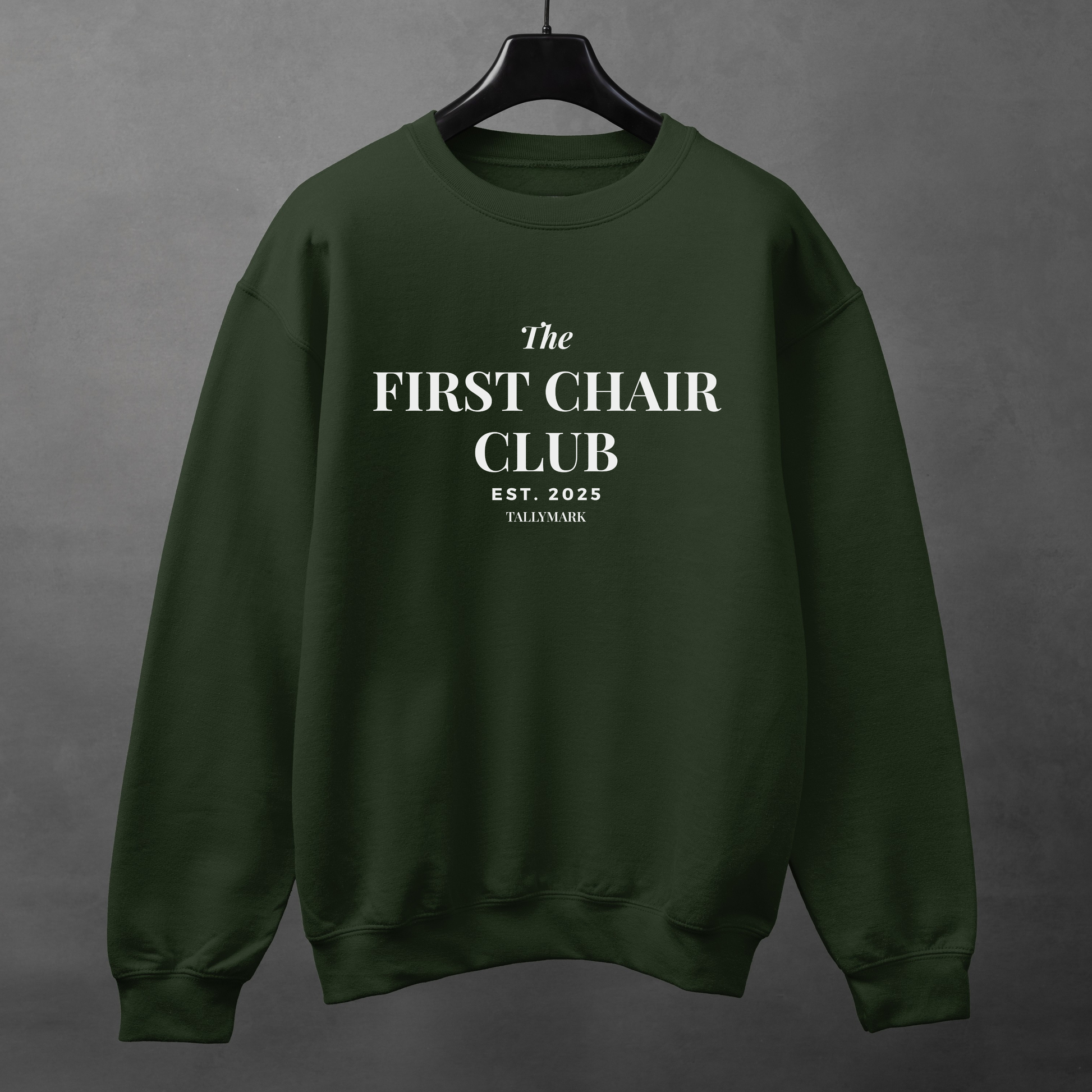 Green sweatshirt with 'The First Chair Club' text on a gray background