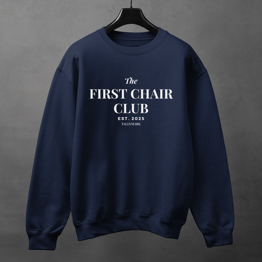 Navy blue sweatshirt with 'The First Chair Club' text on a gray background