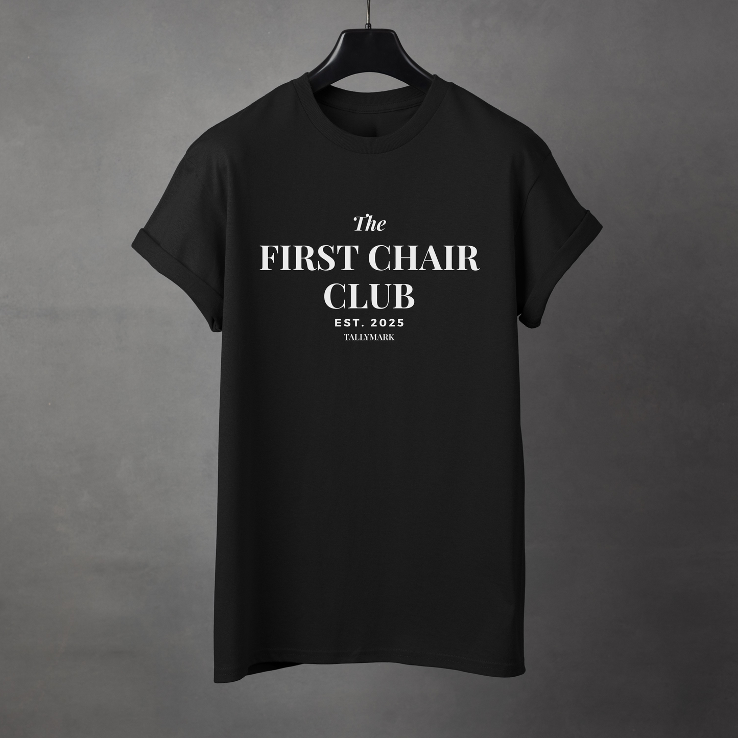 Black t-shirt with 'The First Chair Club' text on a gray background