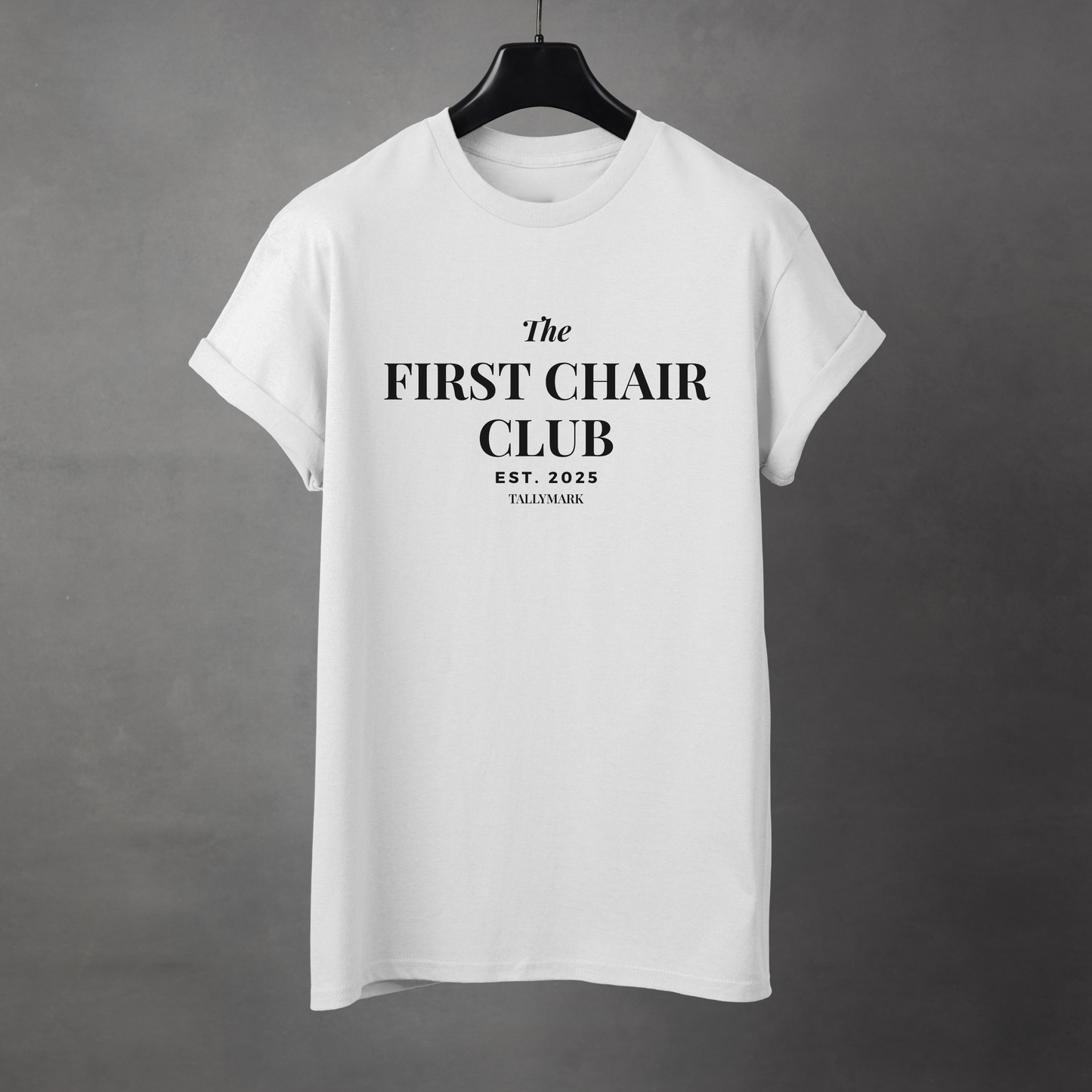 White t-shirt with 'The First Chair Club' text on a gray background
