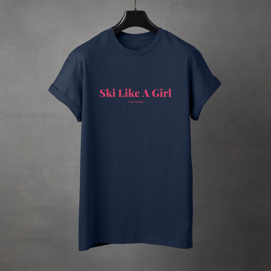 Navy blue t-shirt with pink 'Ski Like A Girl' text against a dark background