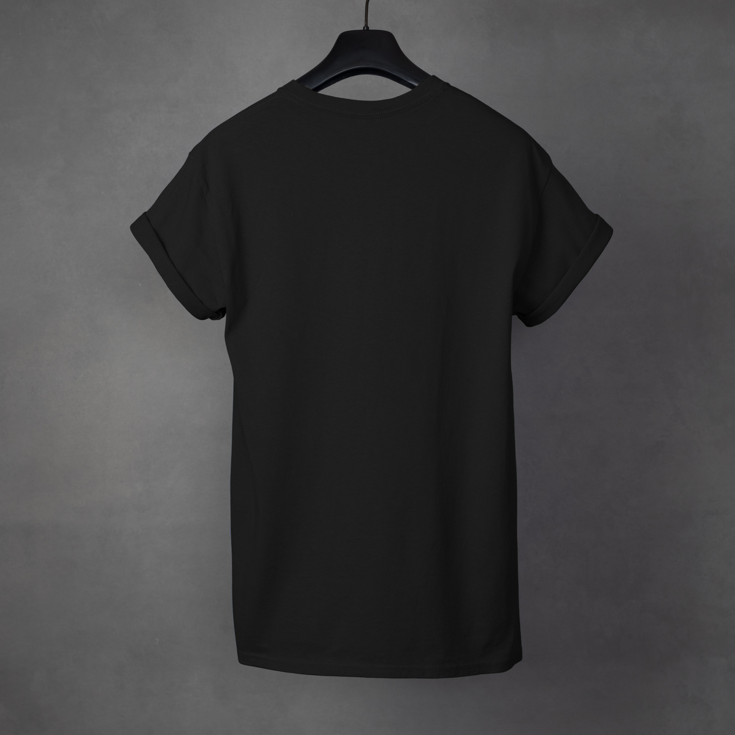 Black t-shirt on a hanger against a gray background