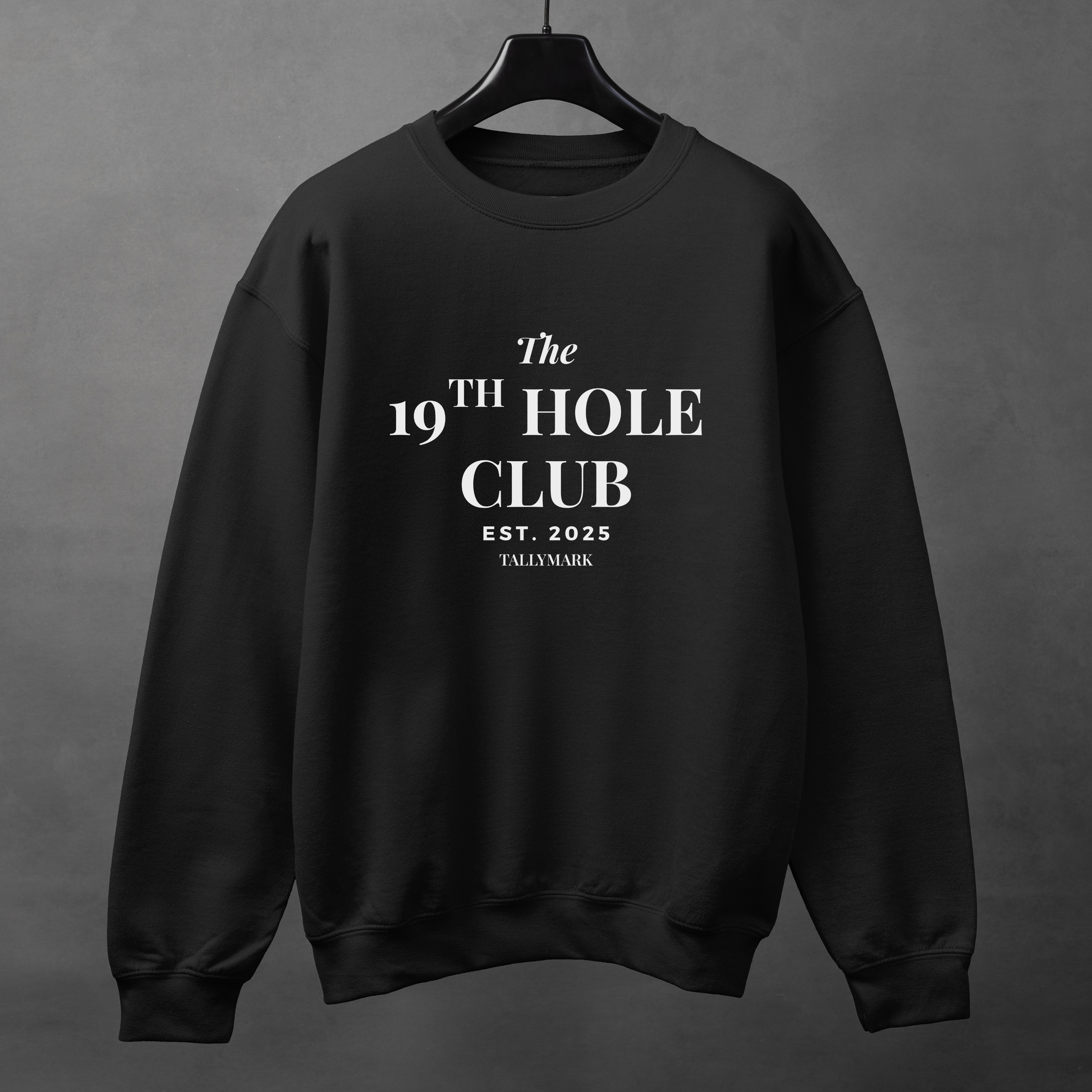Black sweatshirt with "The 19th Hole Club" text against a dark background
