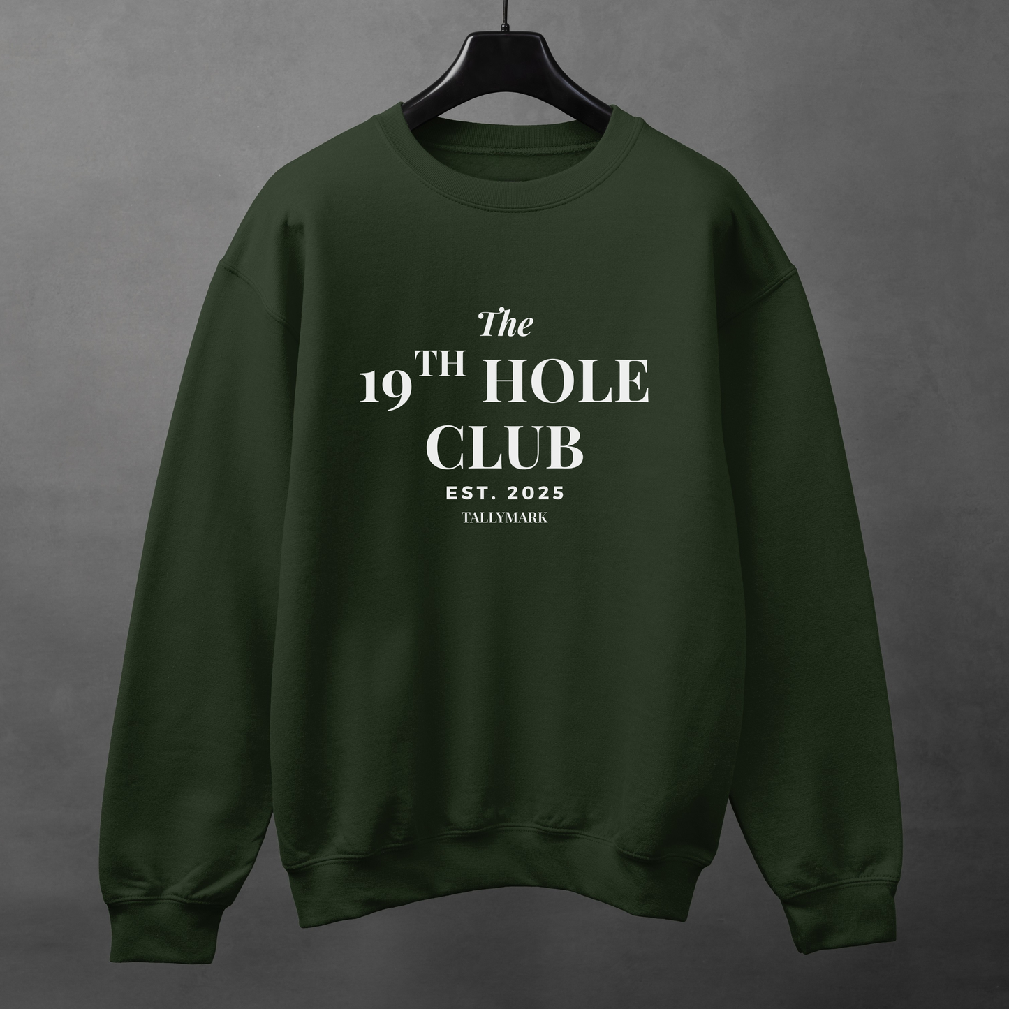 Green sweatshirt with "The 19th Hole Club" text against a dark background