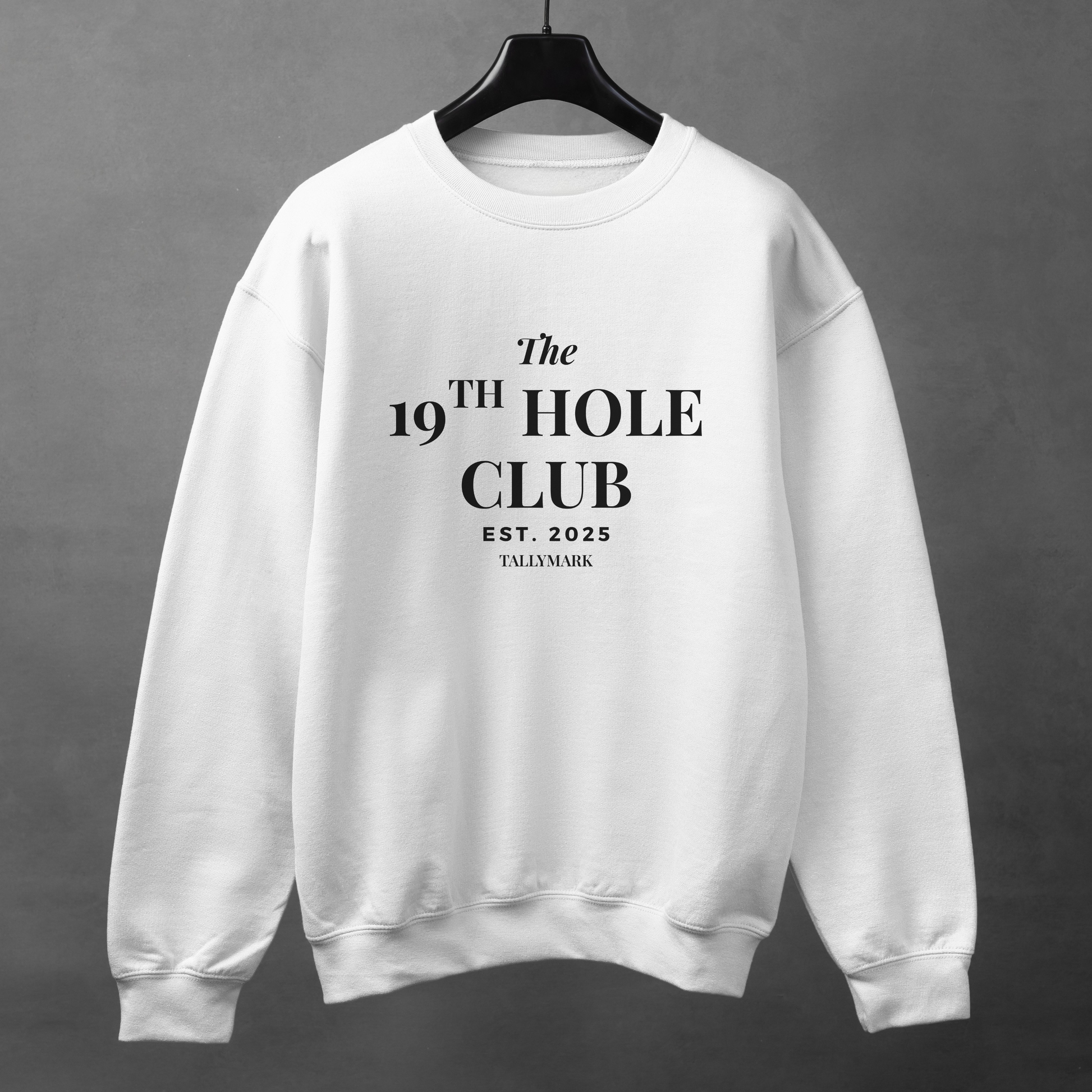 White sweatshirt with "The 19th Hole Club" text against a dark background