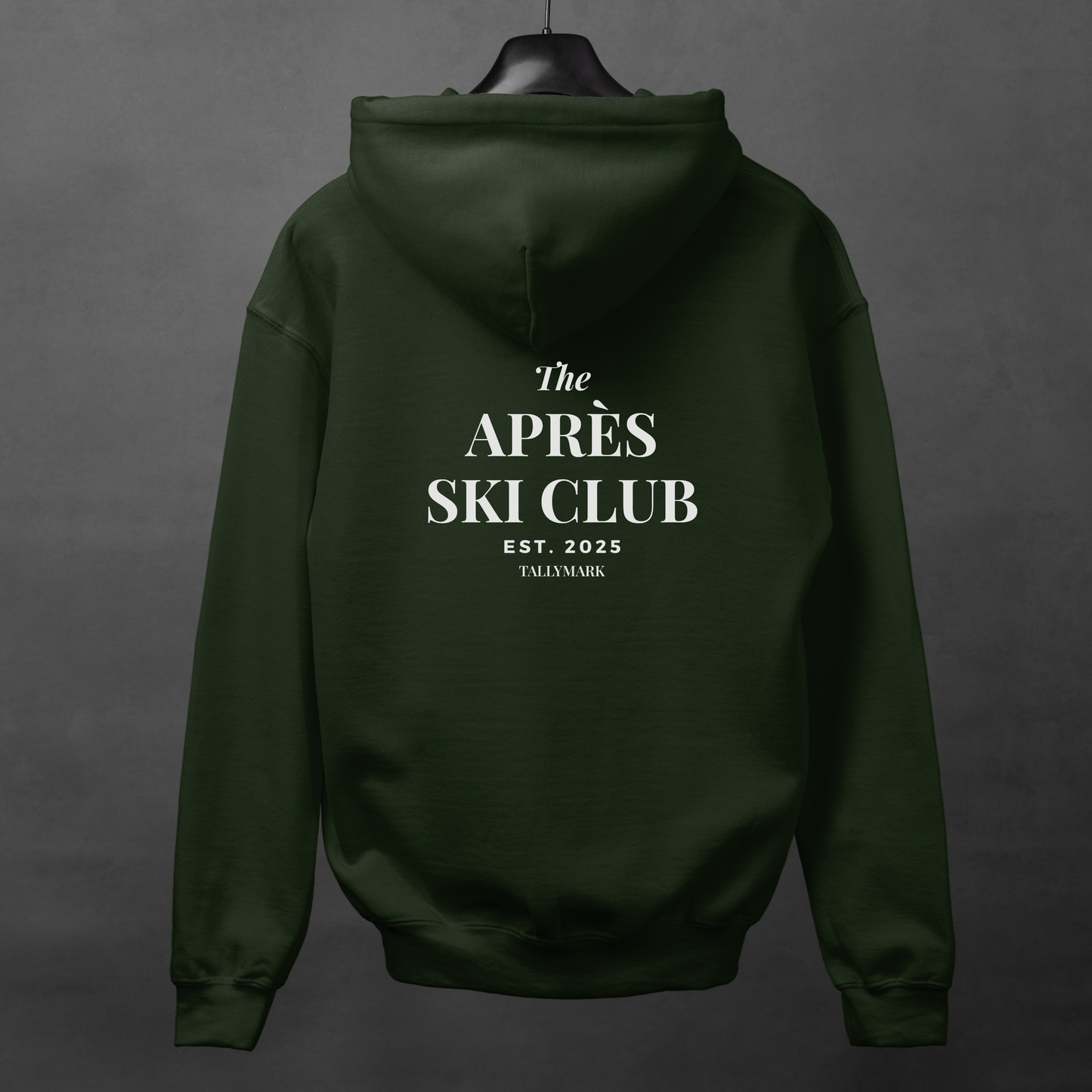 Green hoodie with 'The Après Ski Club' text on the back against a dark background