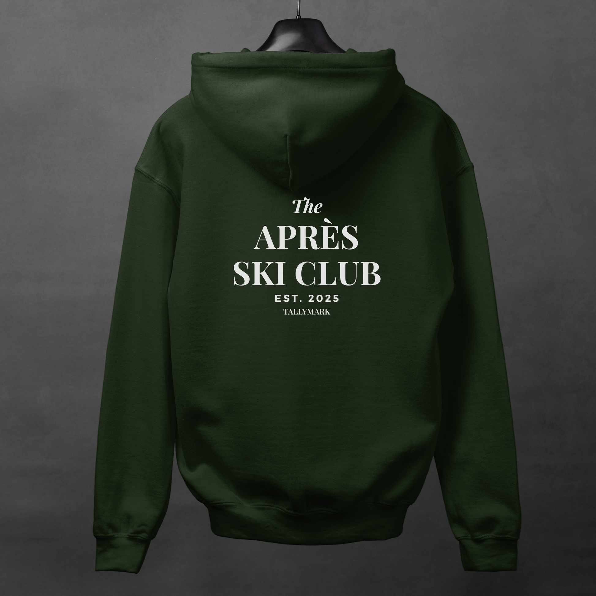 Green hoodie with 'The Après Ski Club' text on the back against a dark background