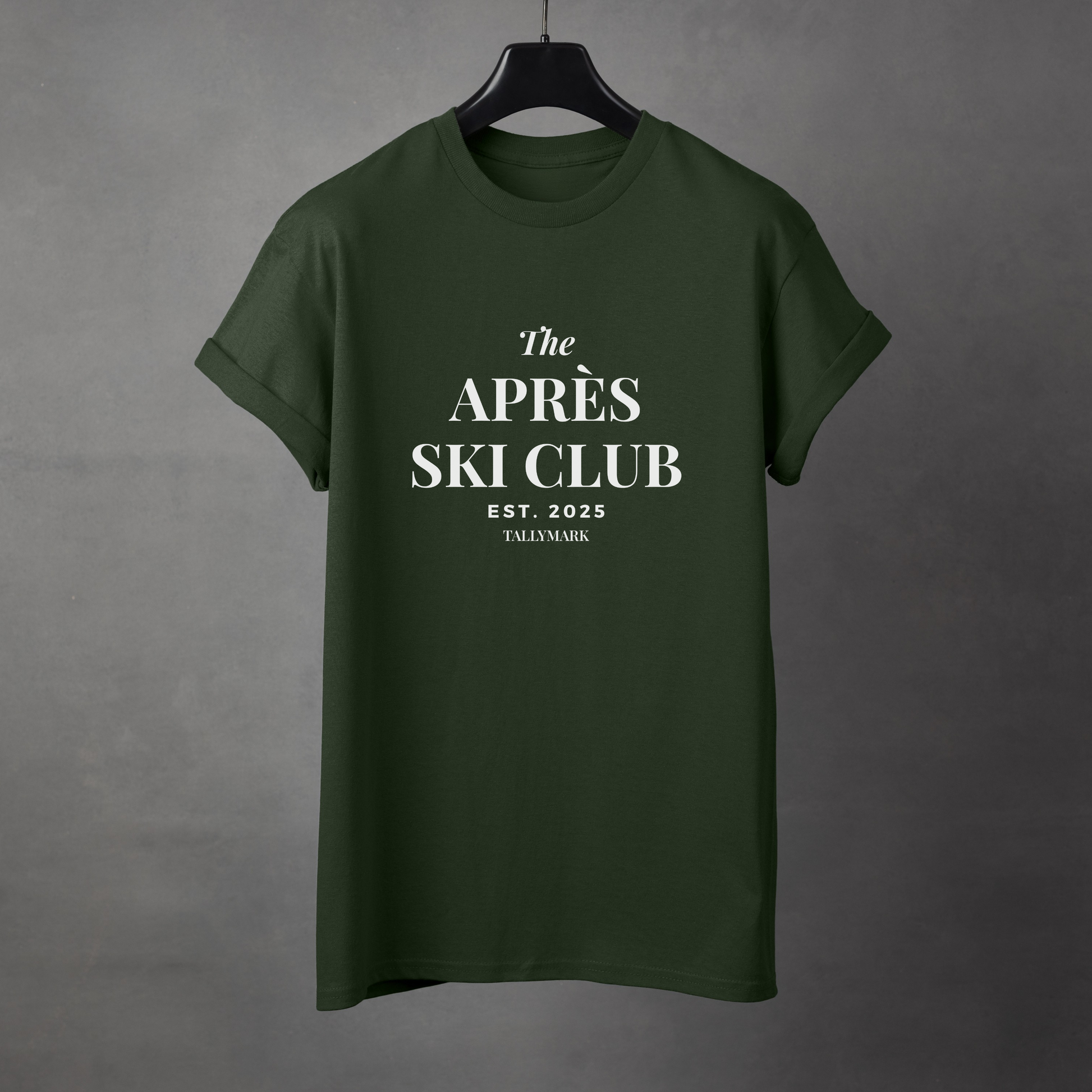 Green t-shirt with 'The Apres Ski Club' text on a gray background