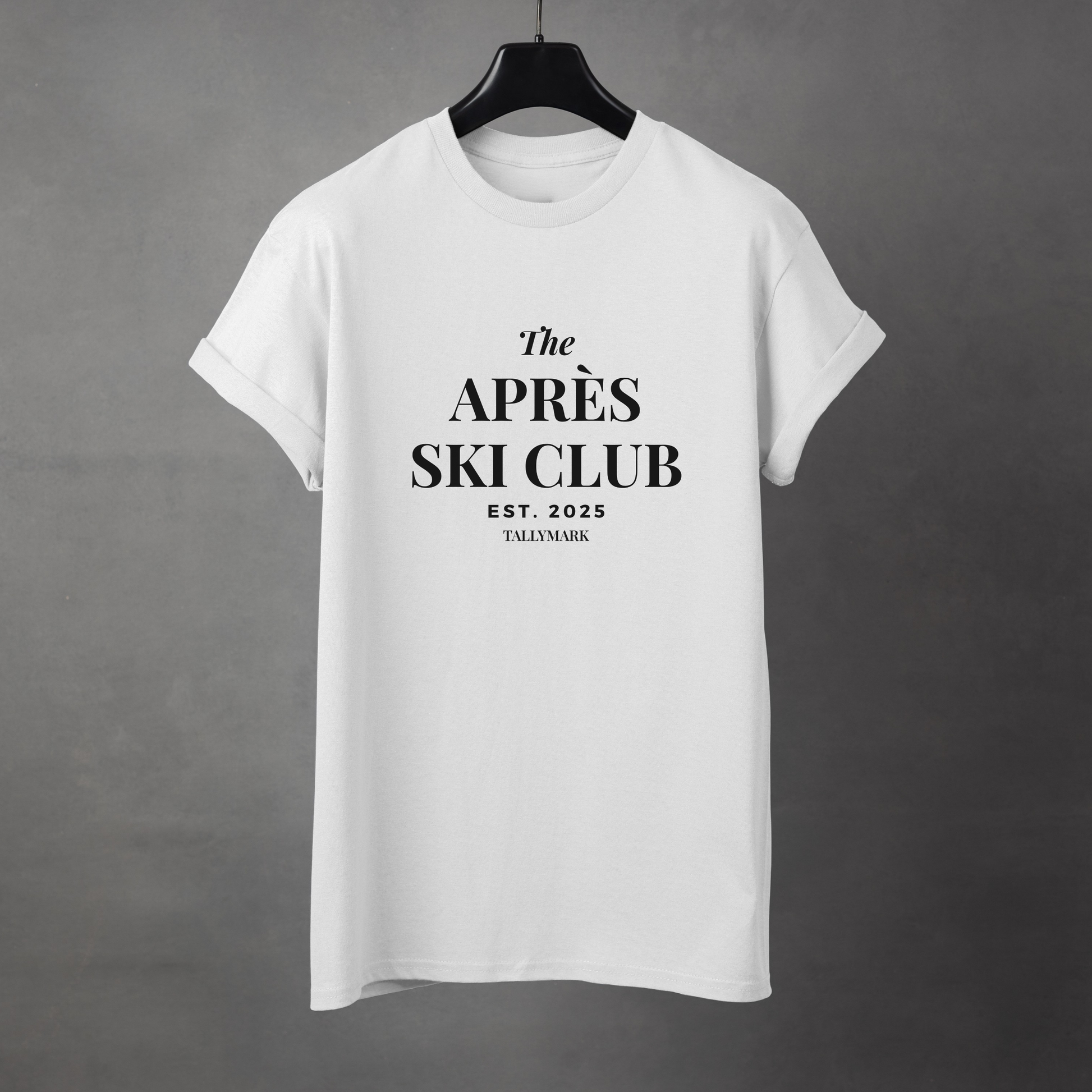 White t-shirt with 'The Après Ski Club' text on a gray background