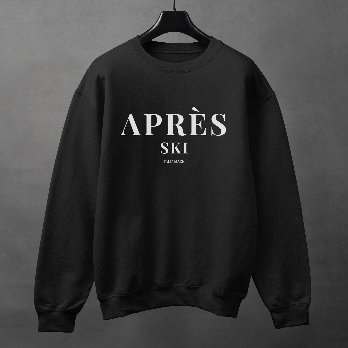Black sweatshirt with 'Après Ski' text against a dark background