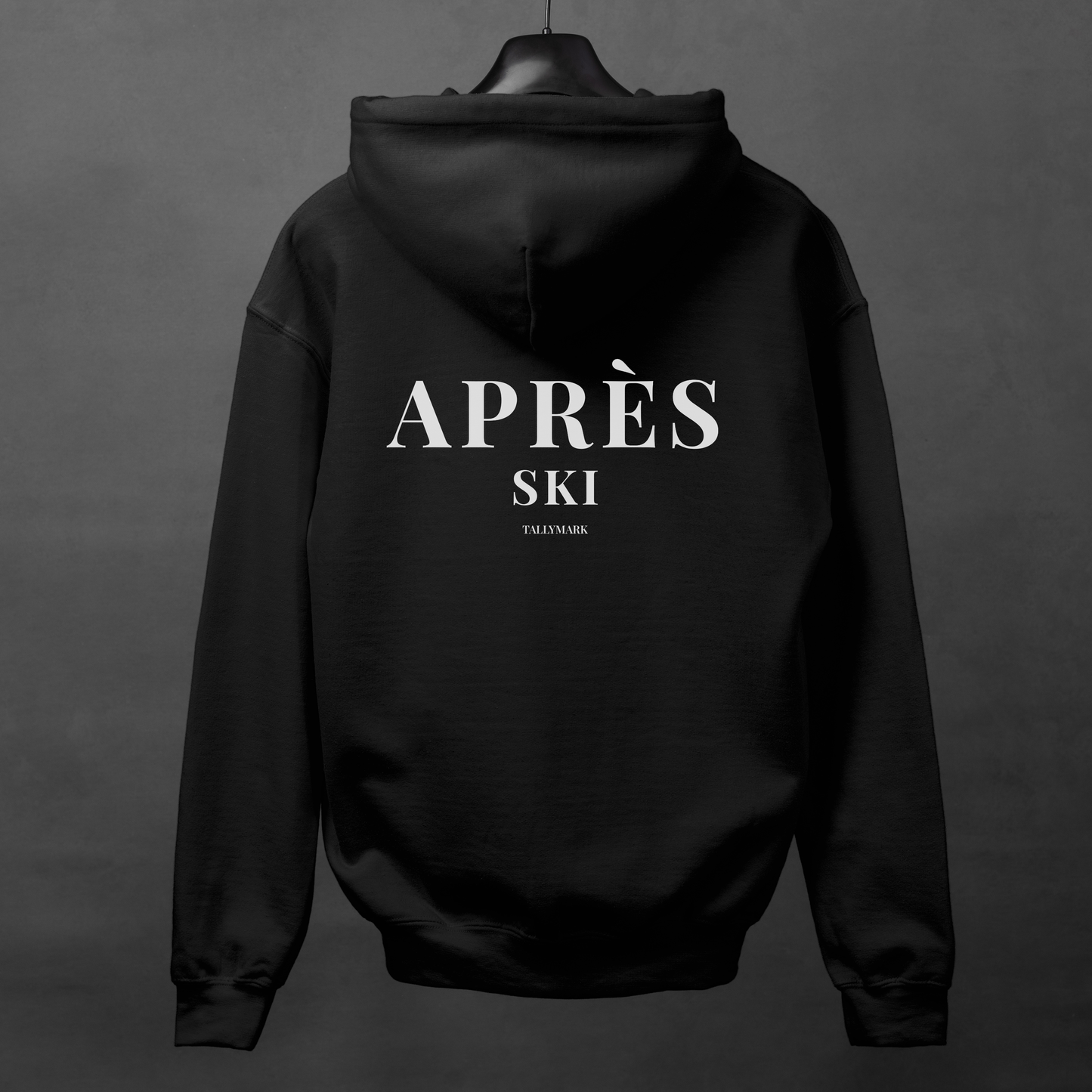 Black hoodie with 'Après Ski' text on the back against a dark background