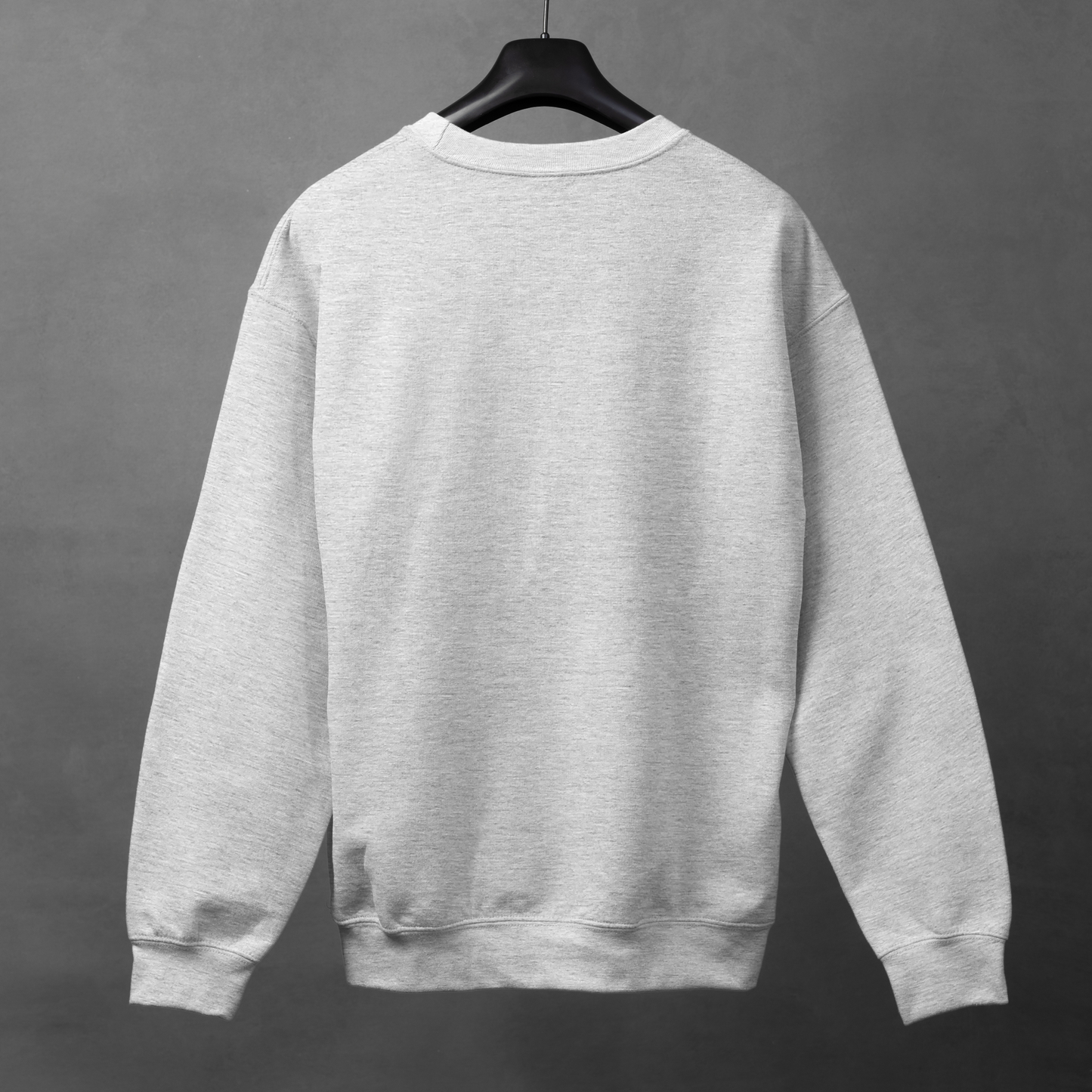 Gray sweatshirt on a hanger against a gray background