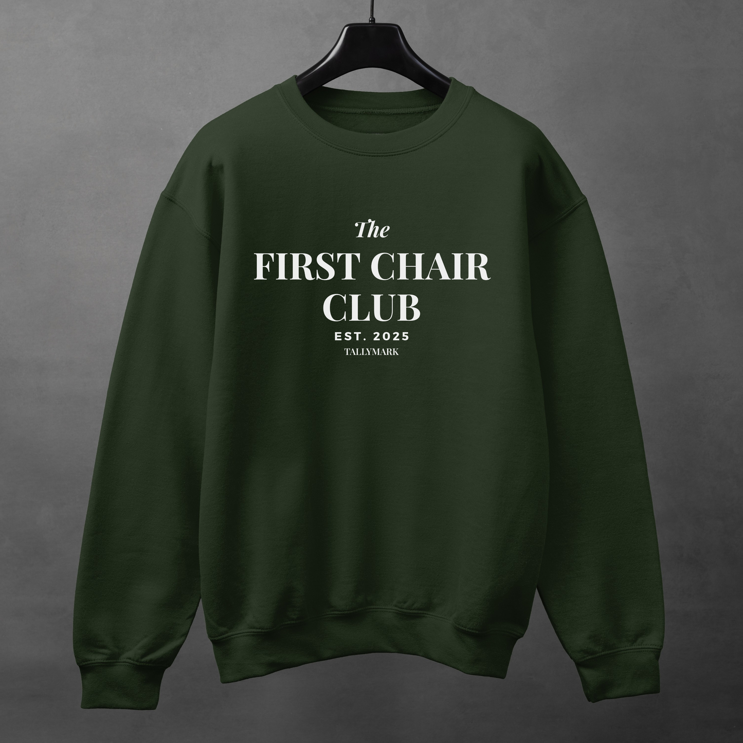 Green sweatshirt with 'The First Chair Club' text on a gray background