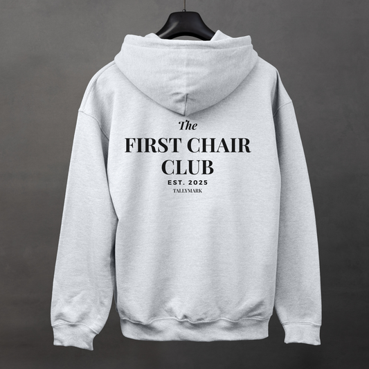 Gray hoodie with 'The First Chair Club' text on the back against a dark background