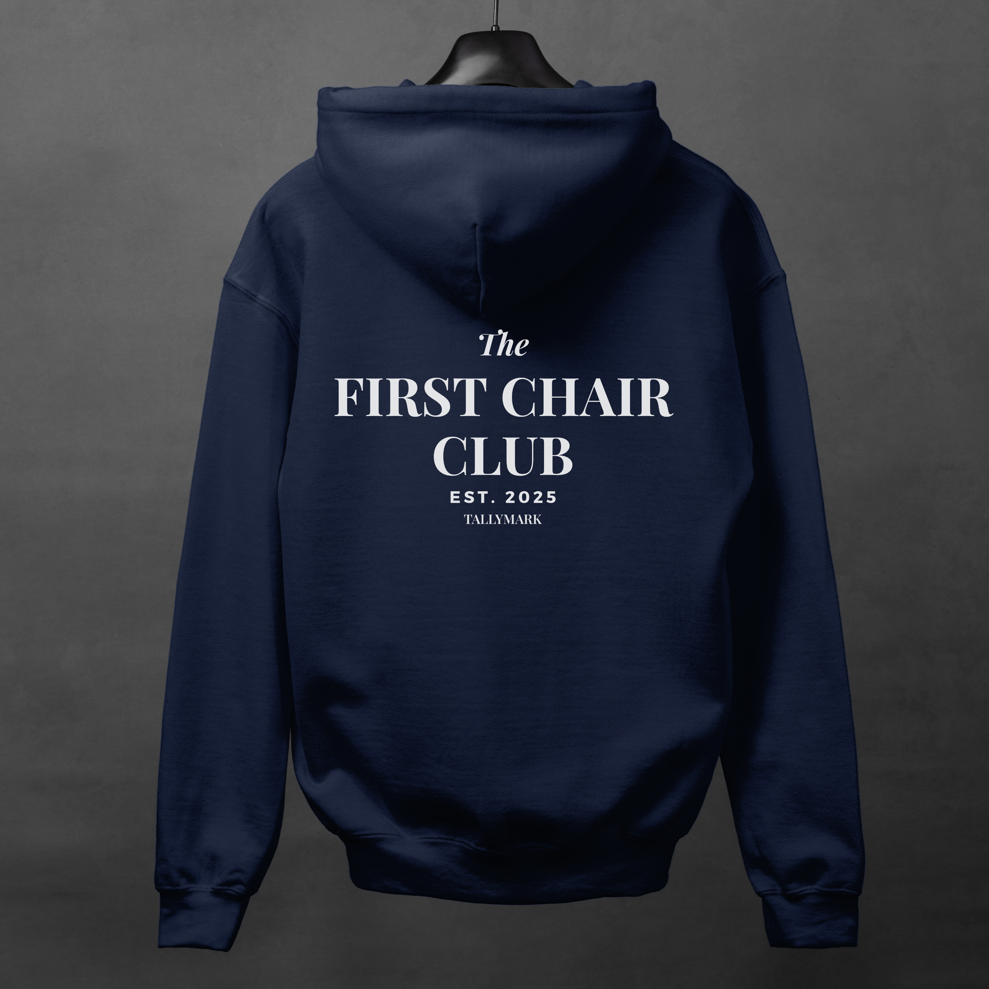 Navy blue hoodie with 'The First Chair Club' text on the back against a dark gray background