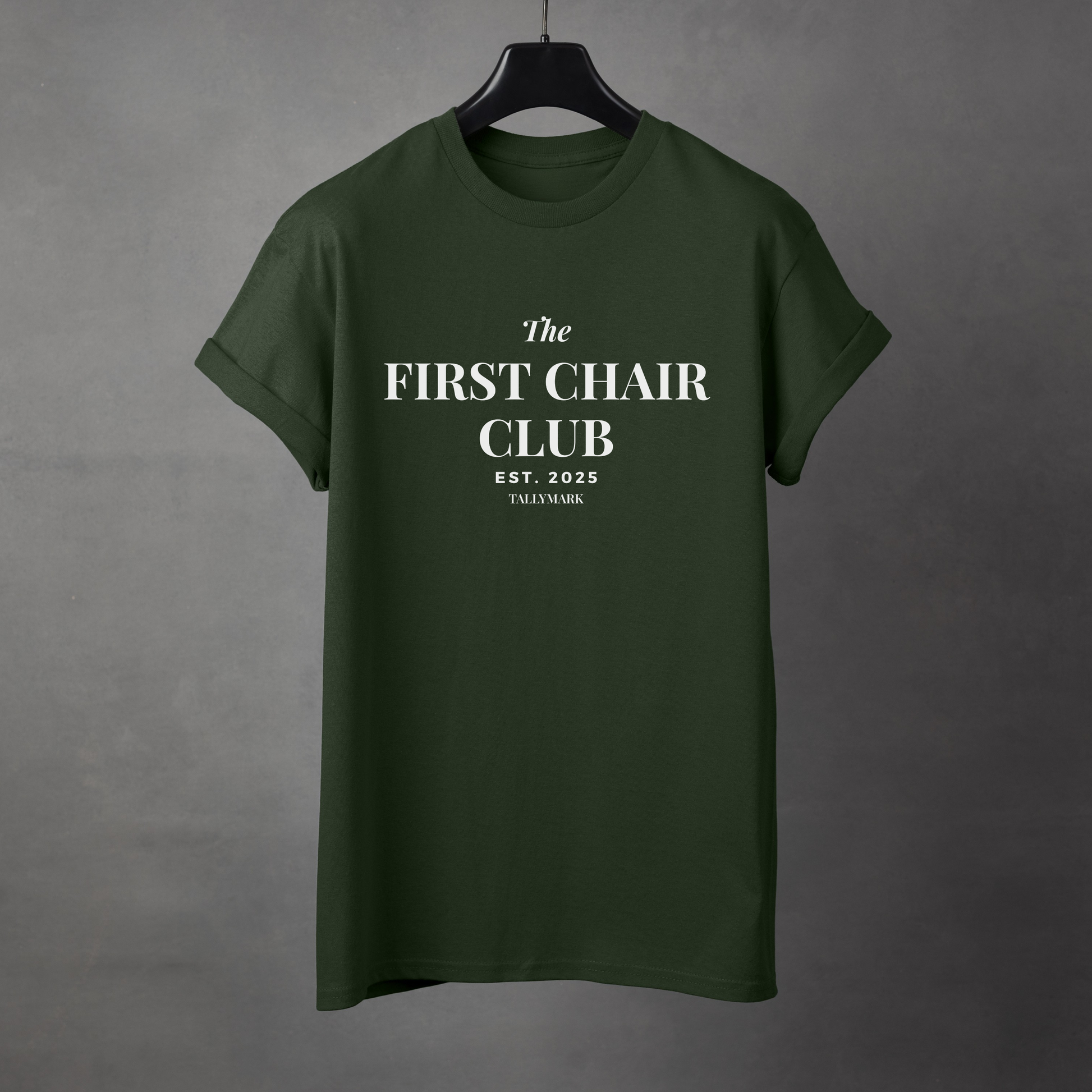 Green t-shirt with 'The First Chair Club' text on a gray background