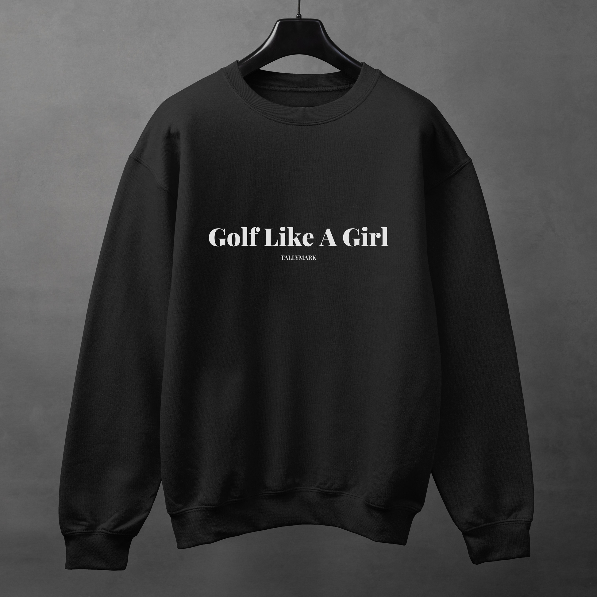 Black sweatshirt with 'Golf Like A Girl' text on a gray background