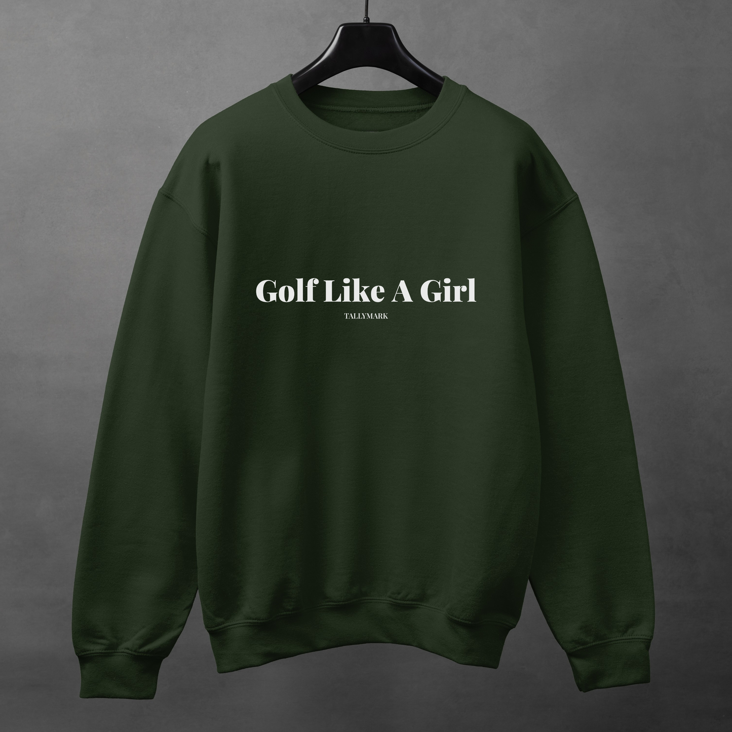 Green sweatshirt with 'Golf Like A Girl' text on a gray background