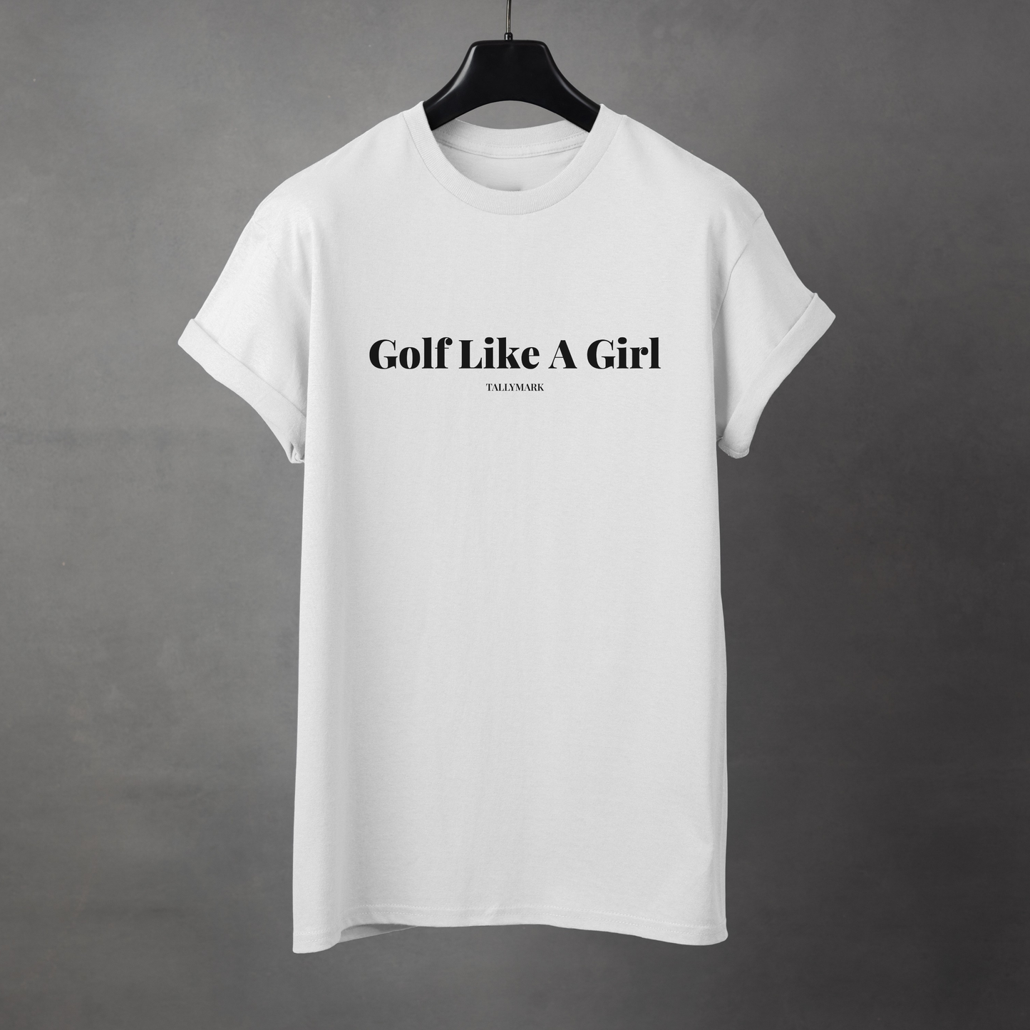 White t-shirt with 'Golf Like A Girl' text against a dark background