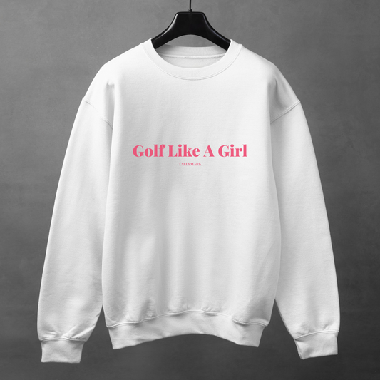 White sweatshirt with pink 'Golf Like A Girl' text against a dark background