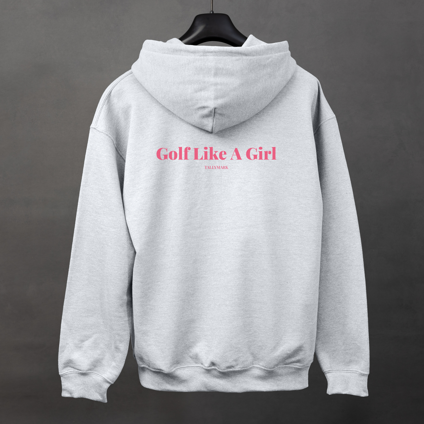 Gray hoodie with pink "Golf Like A Girl" text on the back against a dark background
