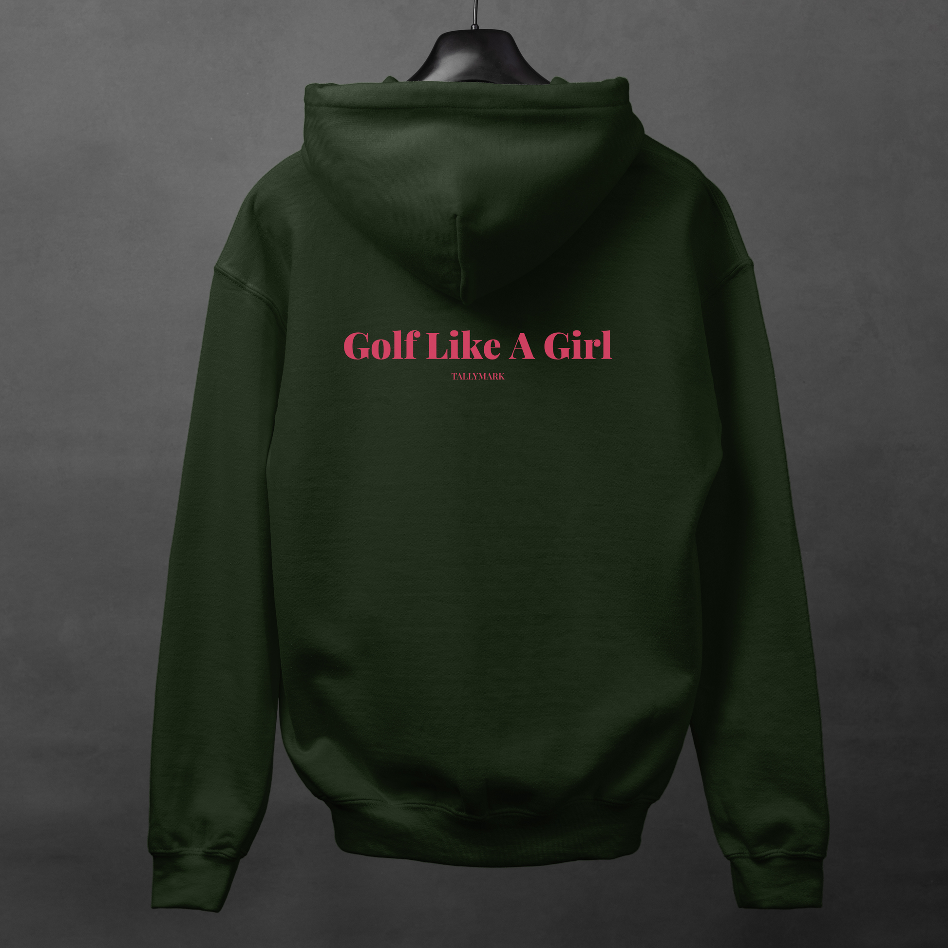 Green hoodie with pink "Golf Like A Girl" text on the back against a dark background