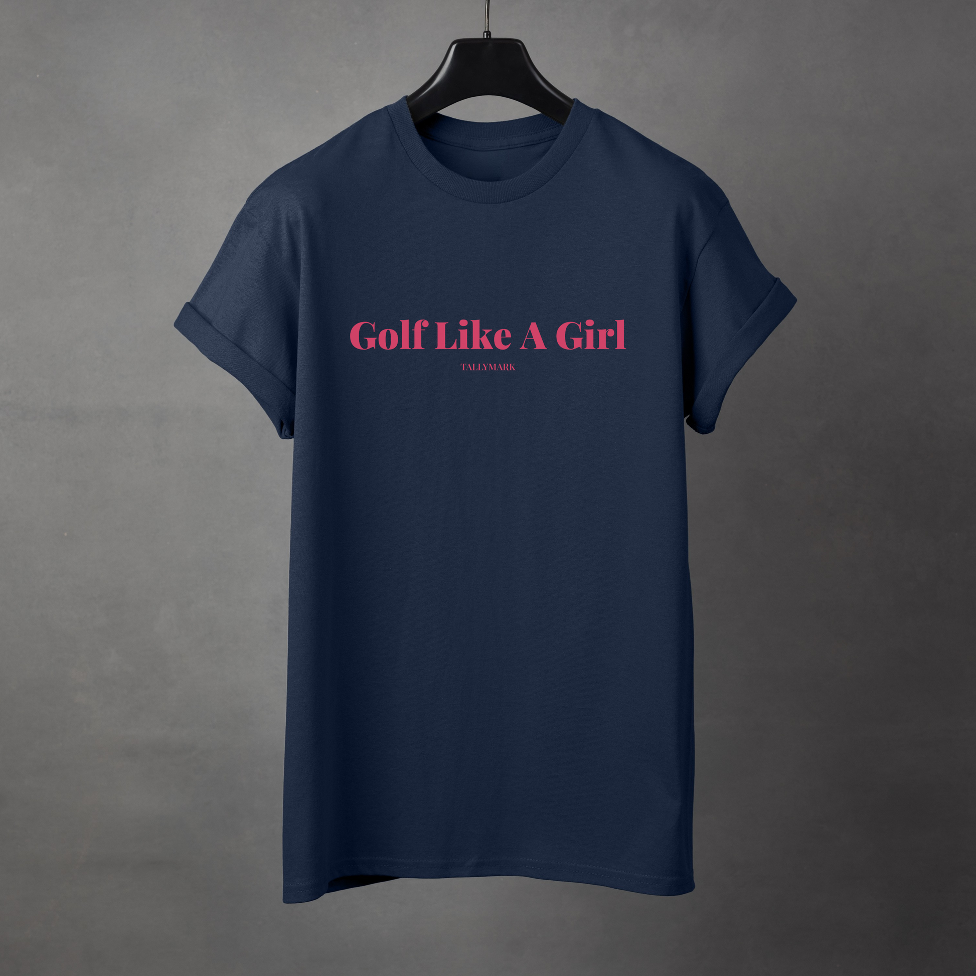 Navy blue t-shirt with pink 'Golf Like A Girl' text against a dark background