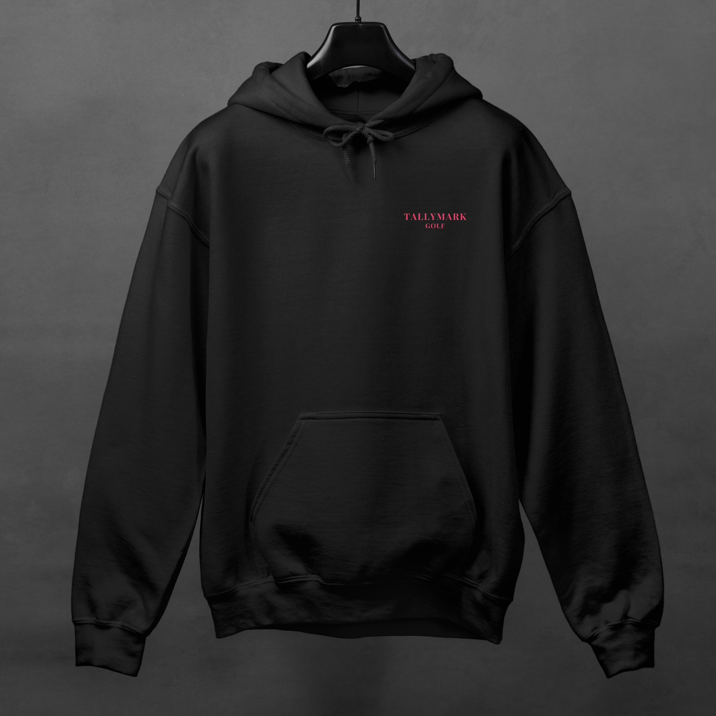 Black hoodie with pink 'TALLYMARK GOLF' logo on a gray background