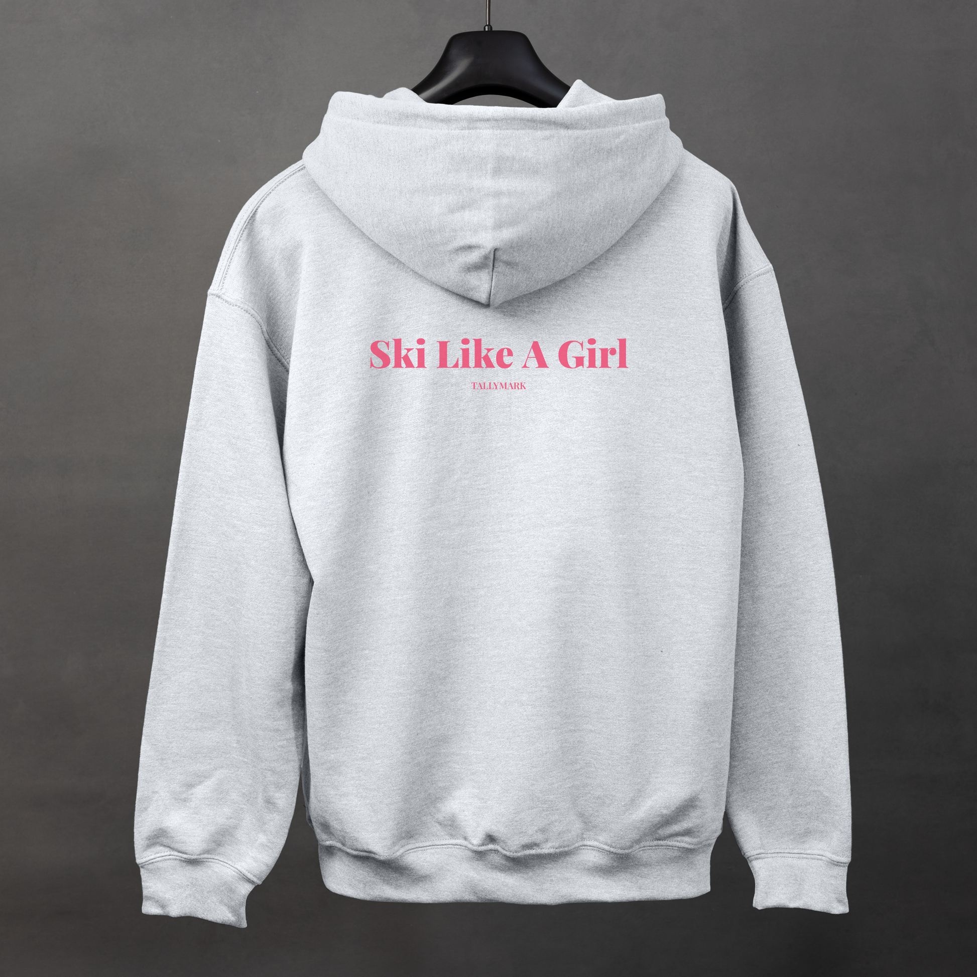 Gray hoodie with pink 'Ski Like A Girl' text on the back against a dark background