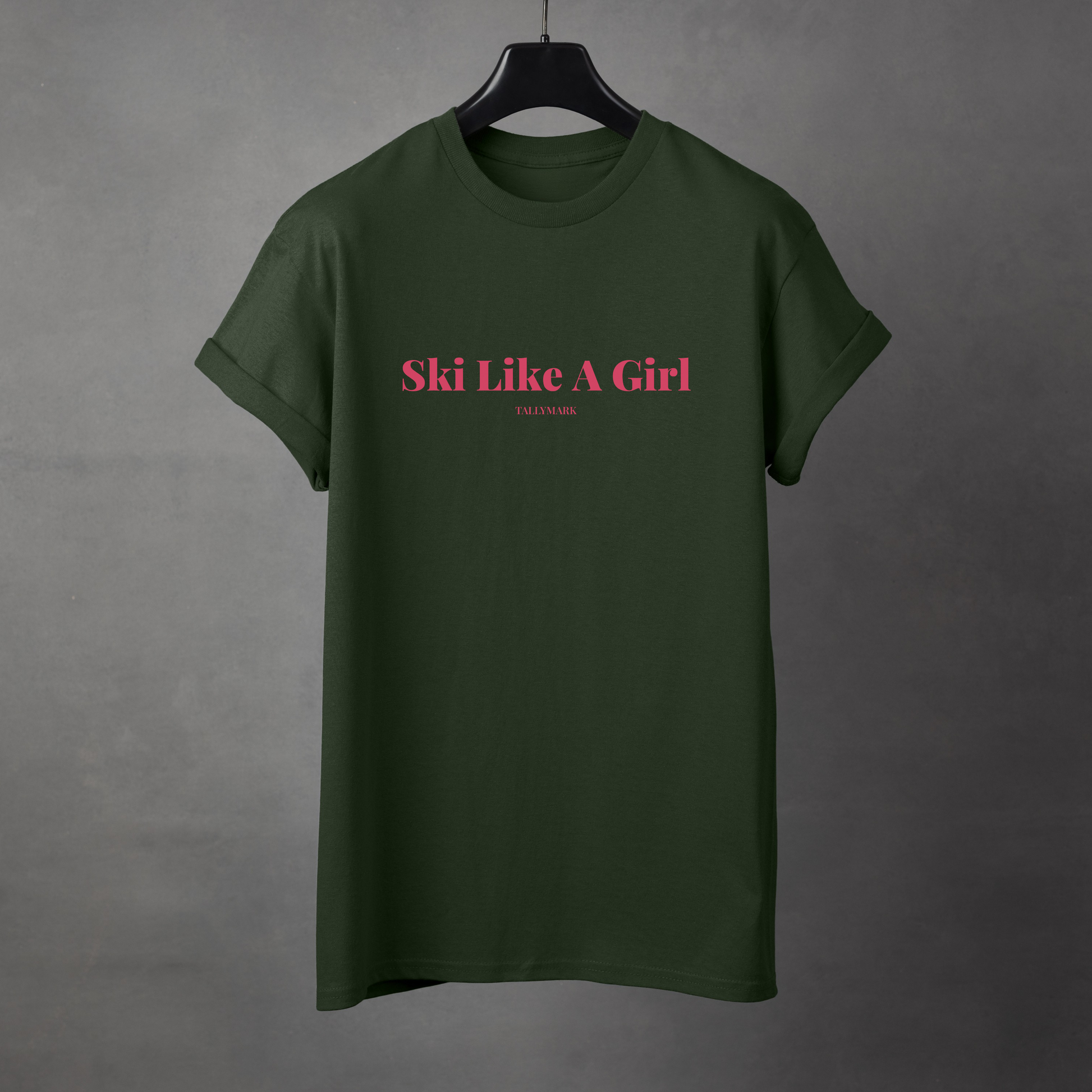 Green t-shirt with pink 'Ski Like A Girl' text against a dark background