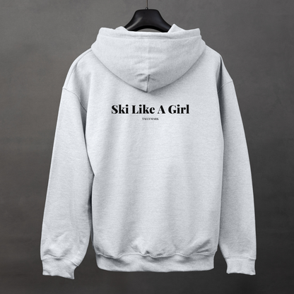 Gray hoodie with 'Ski Like A Girl' text on the back, displayed on a hanger against a dark background.