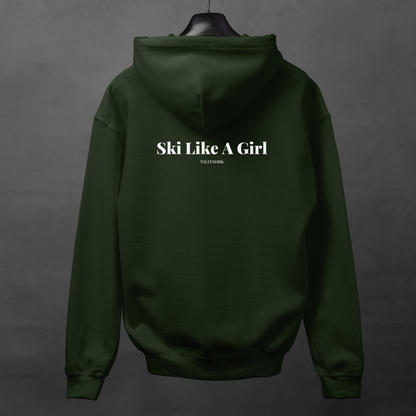 Green hoodie with 'Ski Like A Girl' text on the back, displayed on a hanger against a dark background.