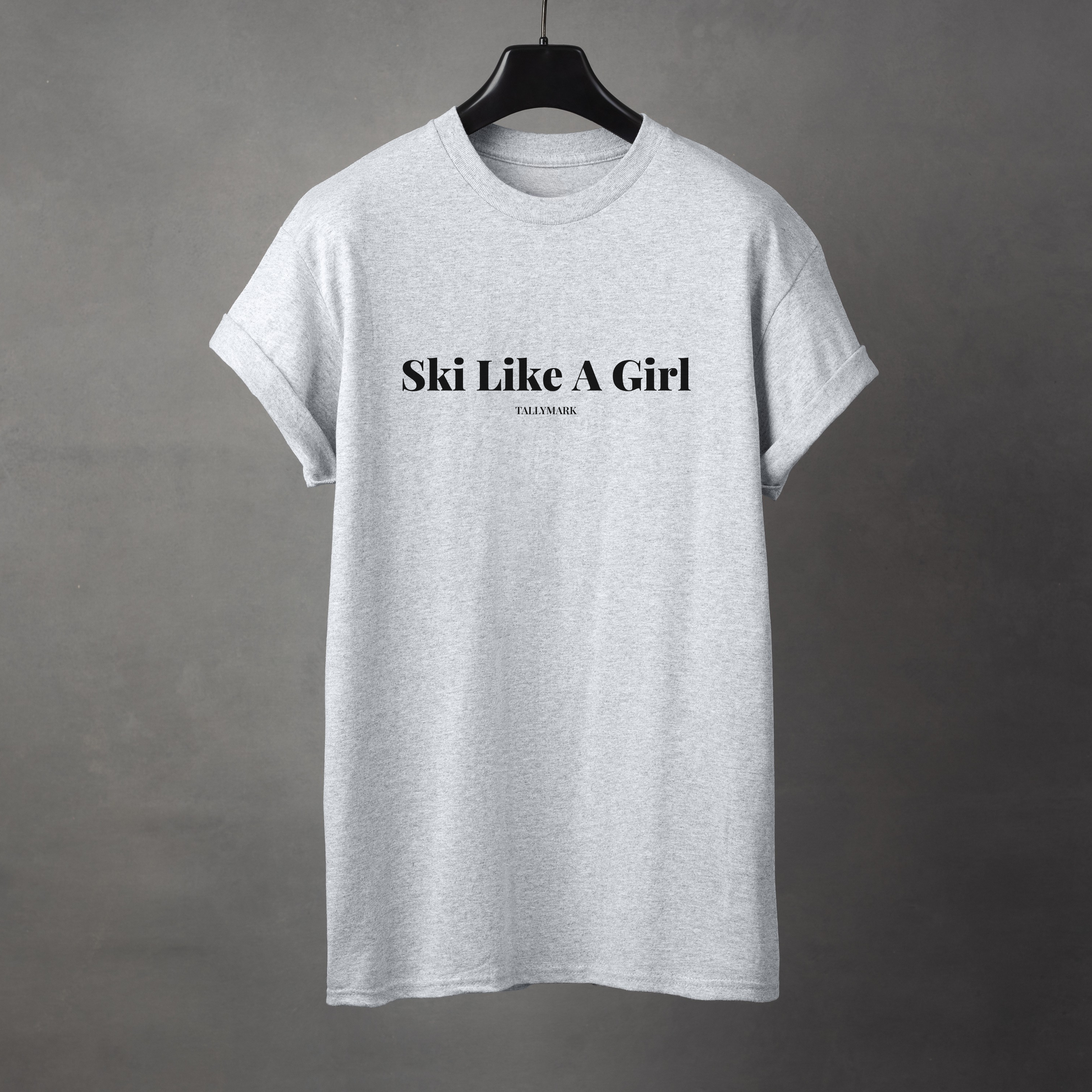 Gray t-shirt with 'Ski Like A Girl' text on a gray background