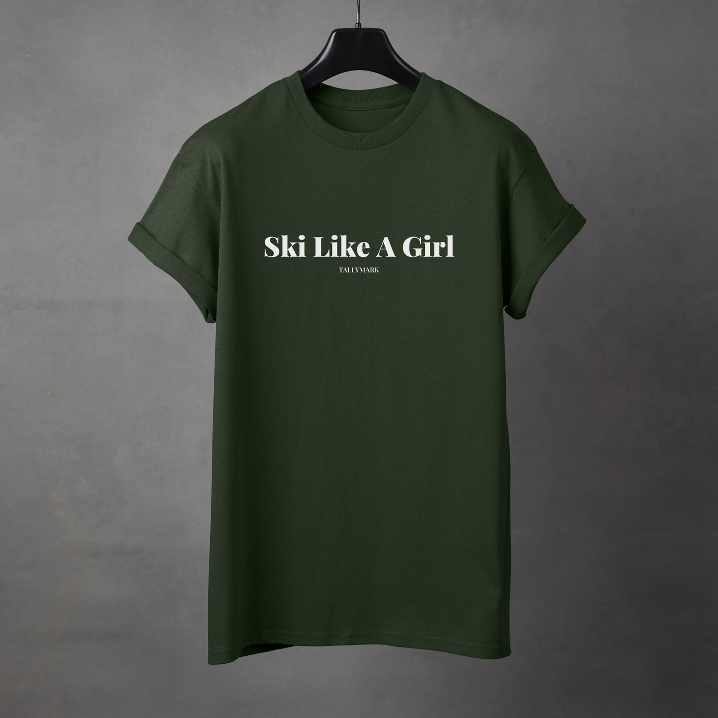 Green t-shirt with 'Ski Like A Girl' text on a gray background