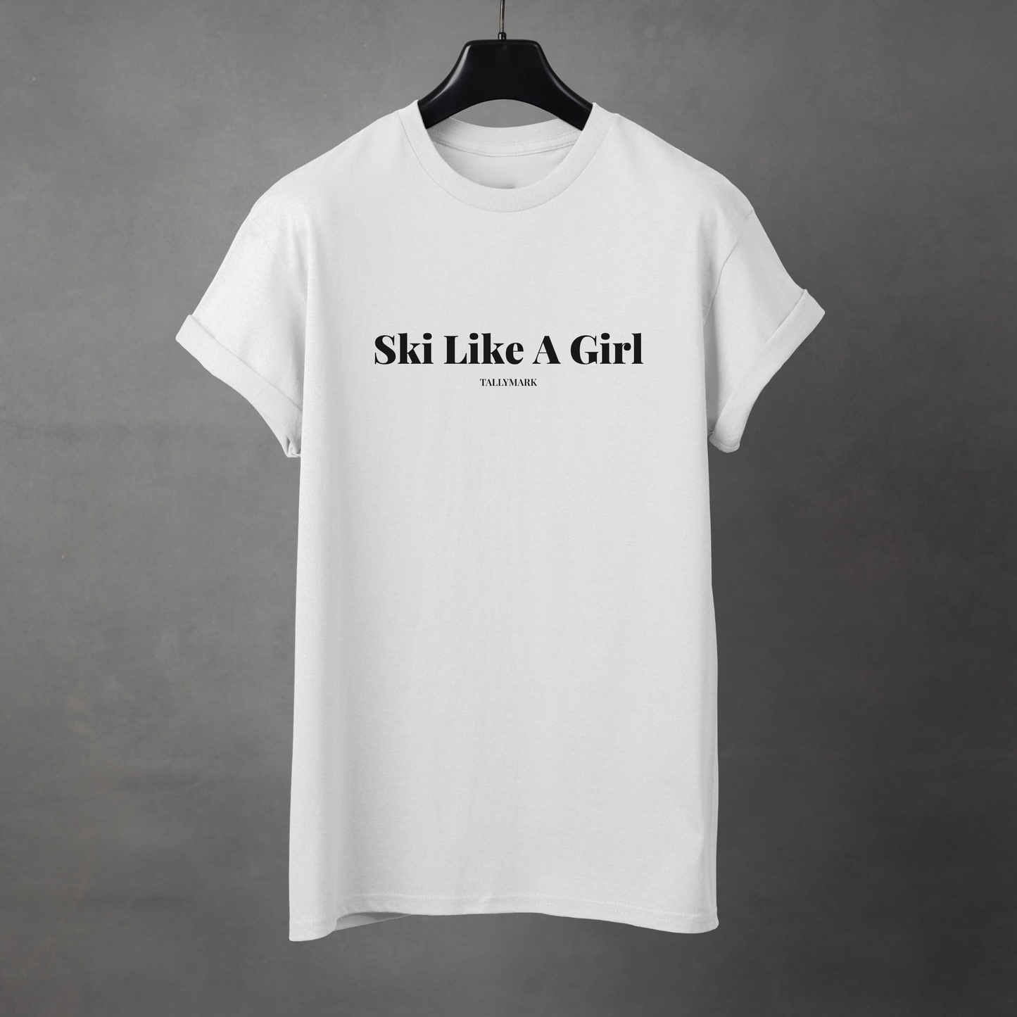 White t-shirt with 'Ski Like A Girl' text on a gray background