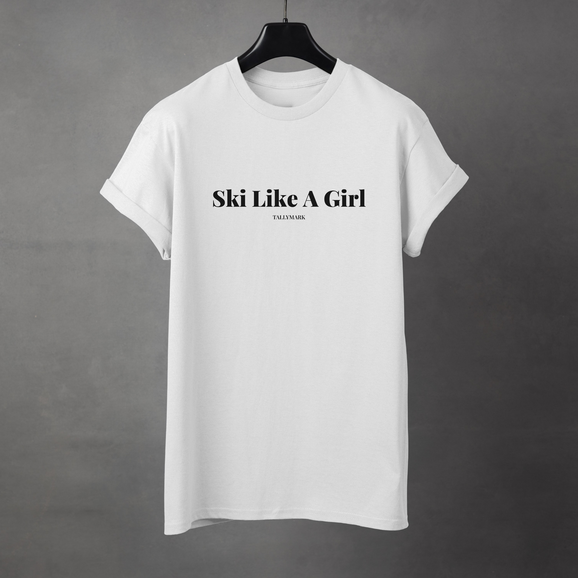 White t-shirt with 'Ski Like A Girl' text on a gray background