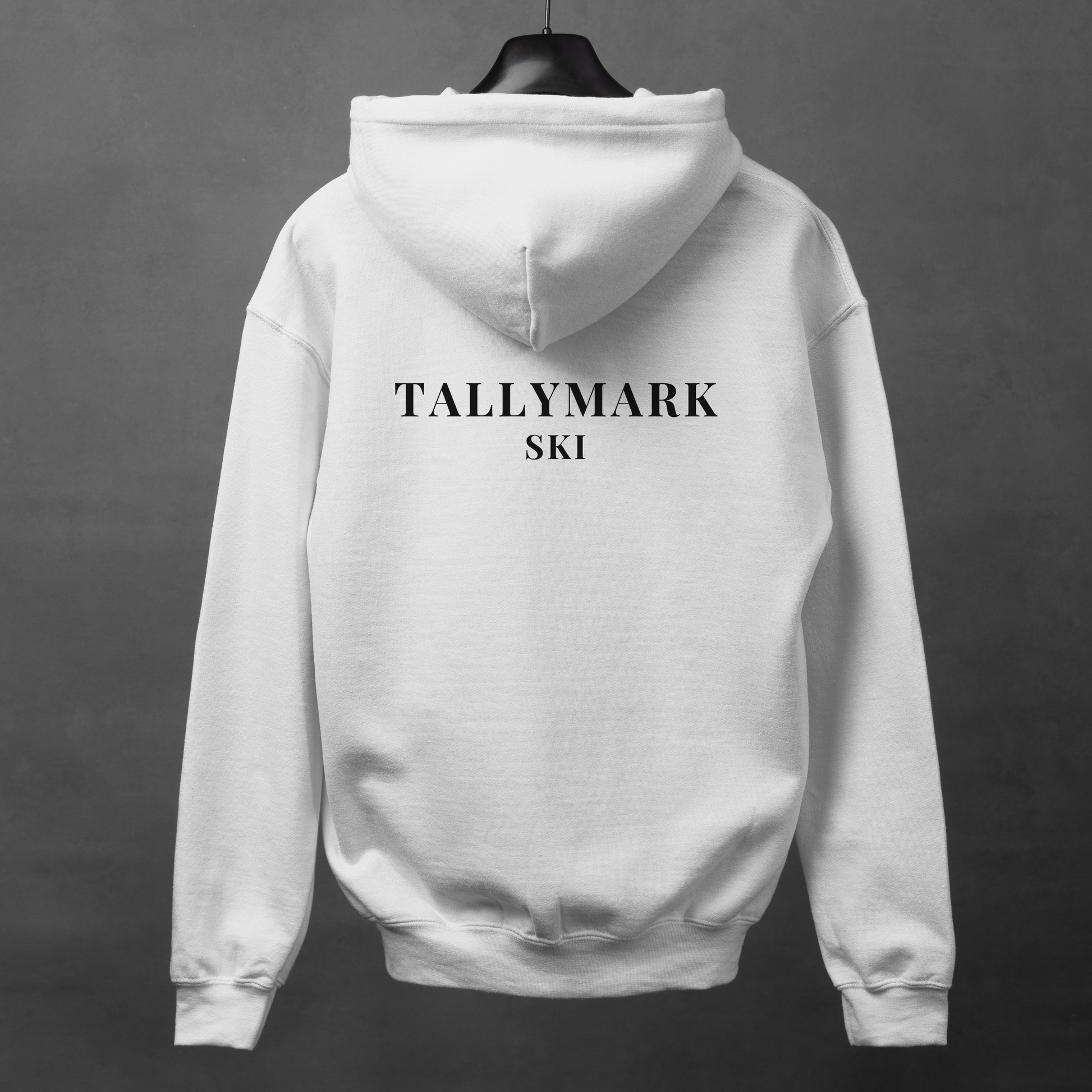 White hoodie with "TALLYMARK SKI" text on the back against a dark background